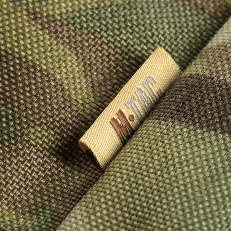Nærbilde av M-Tac sitteunderlag med belte – Multicam, viser detaljer i Multicam-kamuflasje og M-Tac-merke.