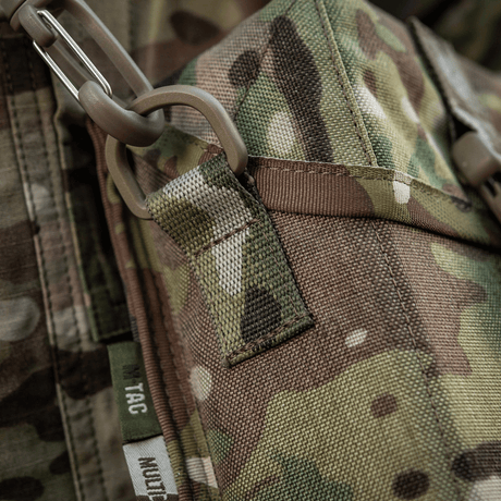 Detalj av M-Tac-veske for nattkikkert PVS-14 i kamuflasjedesign med robust lukking og feste. Ideell for sikker oppbevaring av nattkikkert.