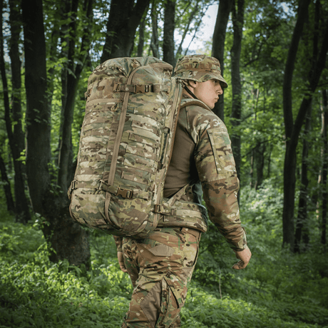 Person med M-Tac Ryggsekk Gen.II Elite Large i kamuflasje i skogmiljø.