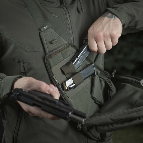 Person bruker M-Tac Double Mag Pouch Hook Backed Magazine for oppbevaring av pistolmagasiner i taktisk veske