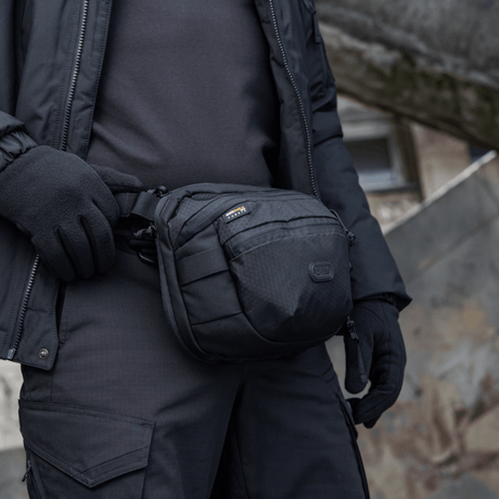M-Tac Sphaera Hex Hardsling Bag i bruk som skulder- eller belteveske, kompakt design, skjult våpenrom, laget av Cordura/Hex polyester.