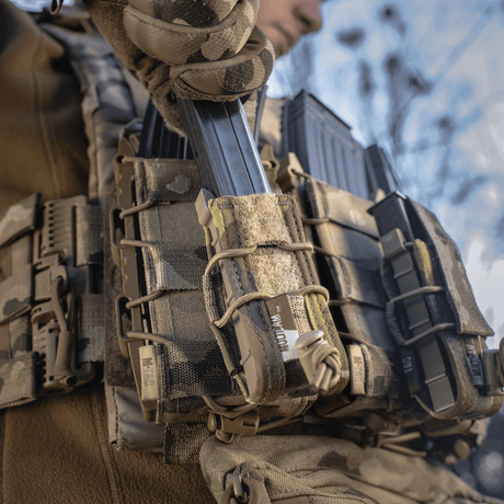 Taktisk utstyr med M-Tac Pistol Mag Pouch Gen.3 montert på MOLLE-system, vist i bruk utendørs.