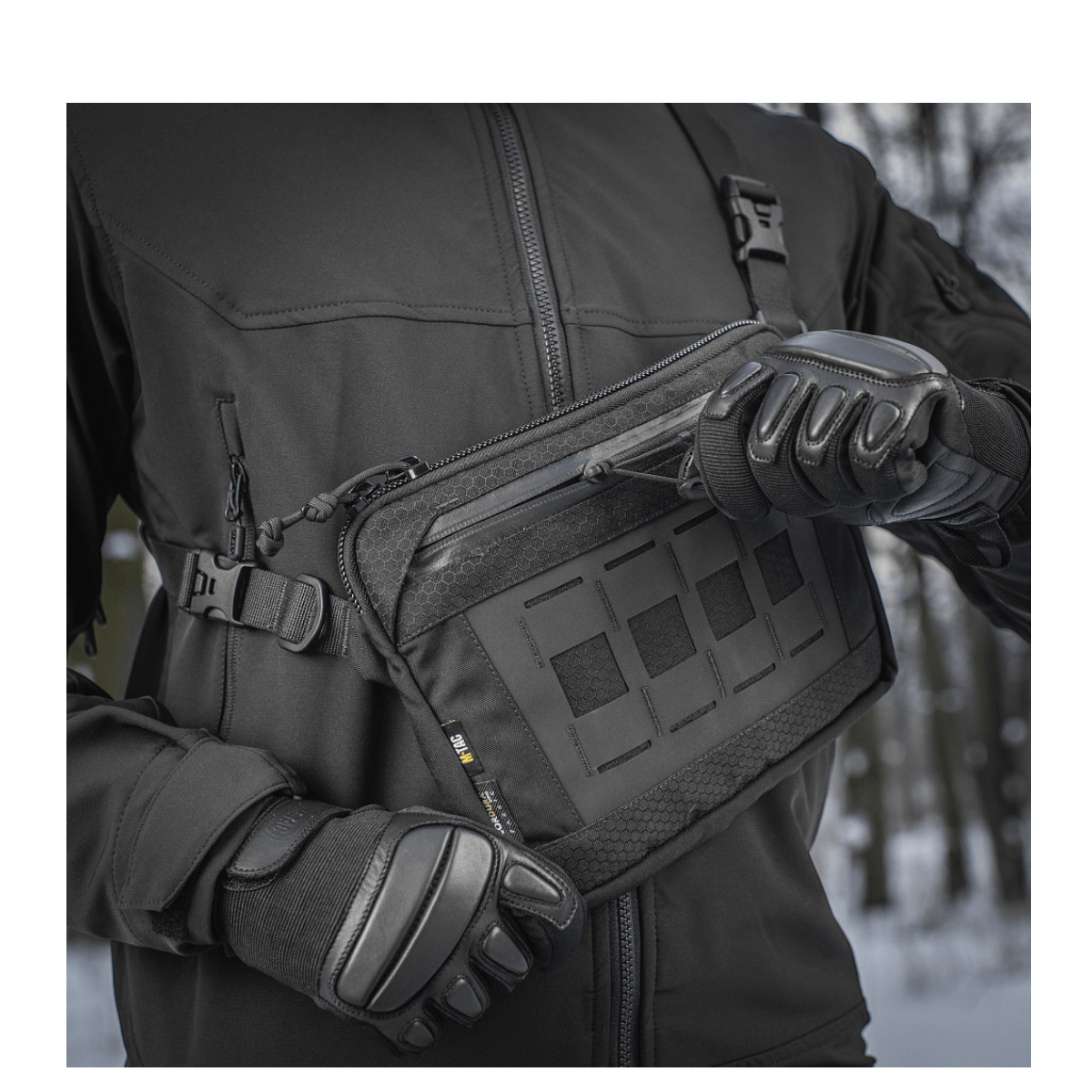 Alt Tag: Person iført M-Tac Admin Taske Elite med Cordura 500D materiale og justerbar skulderrem, omgivet af vinterlandskab