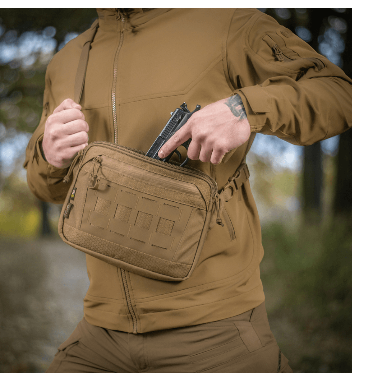 M-Tac Admin Taske Elite i brug udendørs, stærkt og stilfuldt design med justerbar skulderrem og slidstærke materialer, fokus på funktionalitet.