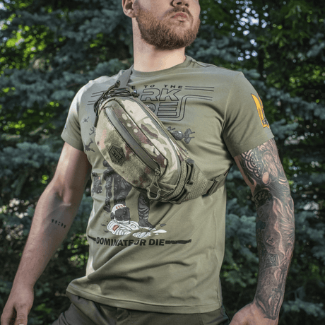 M‑Tac belteveske Elite Hex på en mann i skogen, stilfull og funksjonell takket være Cordura-materiale og taktiske lommer.