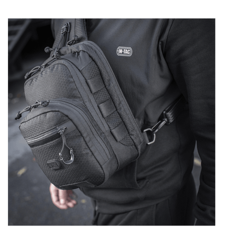 M-Tac Cross Taske Slim Elite Hex båret over skulderen, viser stilfullt design og holdbart Cordura-stoff.