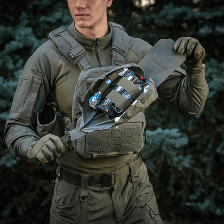 M‑Tac Medic Pouch Vertical Large Elite i bruk på taktiske vester i skogmiljø.