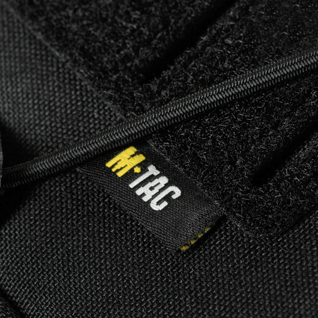 Nærbilde av etikett på M-Tac STURM Elite ryggsekk i Cordura-materiale.