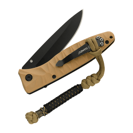 M-Tac Ninja Ver.2 Lanyard festet til en kniv med flettet paracord-design og ninjamotiv, ideell for kniver og små verktøy.