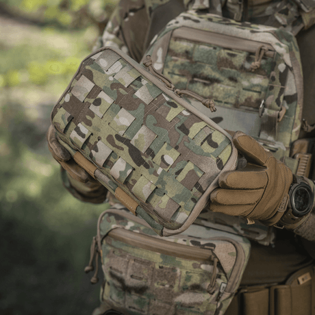 M-Tac Admin Pouch Large Elite i bruk, holdt av person i taktisk utstyr, kamuflasjemønster, robust Cordura 500D-materiale.