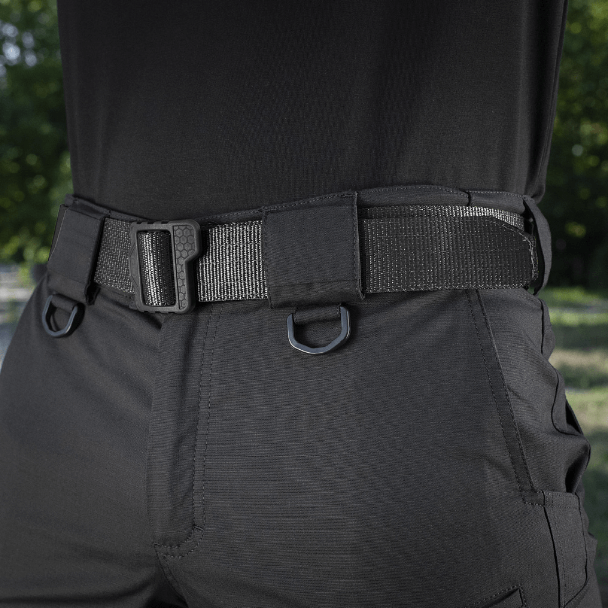 M-Tac Shorts Aggressor Gen.II Flex in black with tactical belt, close-up view highlighting durability and flexibility outdoors.