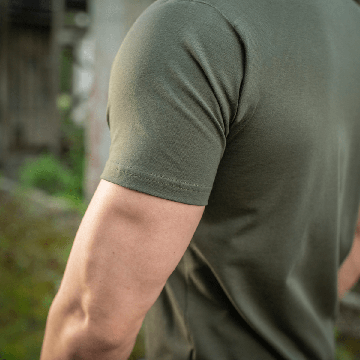 M-Tac T-shirt 93/7 Summer in olive green worn outdoors, highlighting the comfortable, breathable fabric and fitted design.