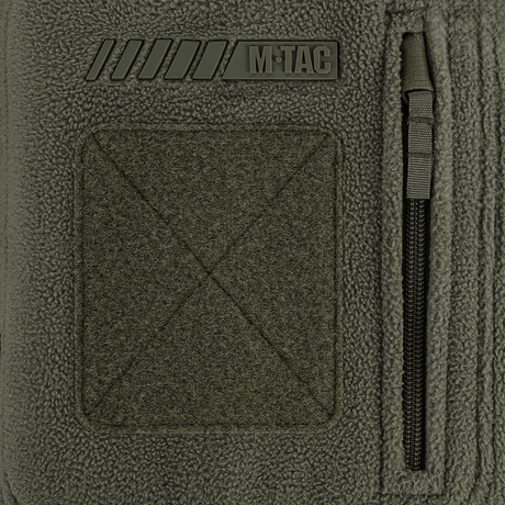 Detalje af M-Tac Division Gen.II Windblock Fleecejakke med logo og lynlås, designet til maksimal varme og beskyttelse mod vind.