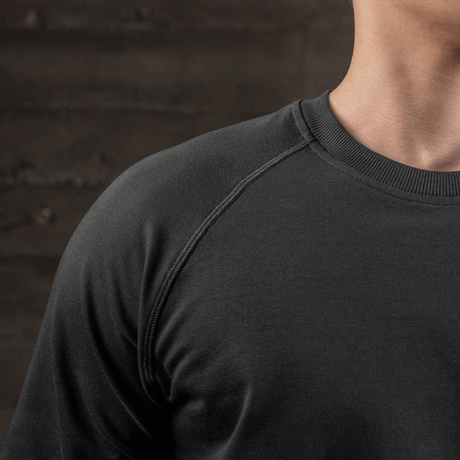 Nærbilde av M-Tac Raglan Athlete-sweatshirt, svart, med raglanermer og rund hals.