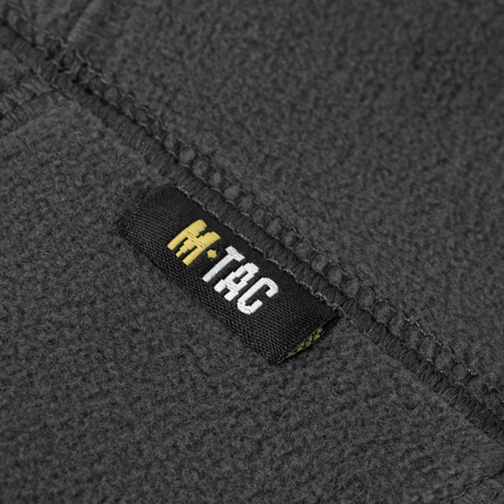 Etiketten på M-Tac Polartec Anatomic Tube Scarf lavet af Polartec® Micro Series fleece. Fleecematerialet er gråt og holdbart.