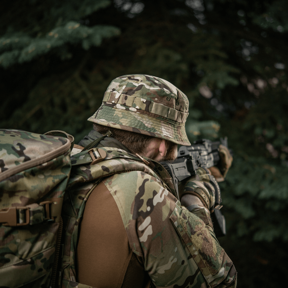 Spec-ops camouflage uniform with tactical gear in forest