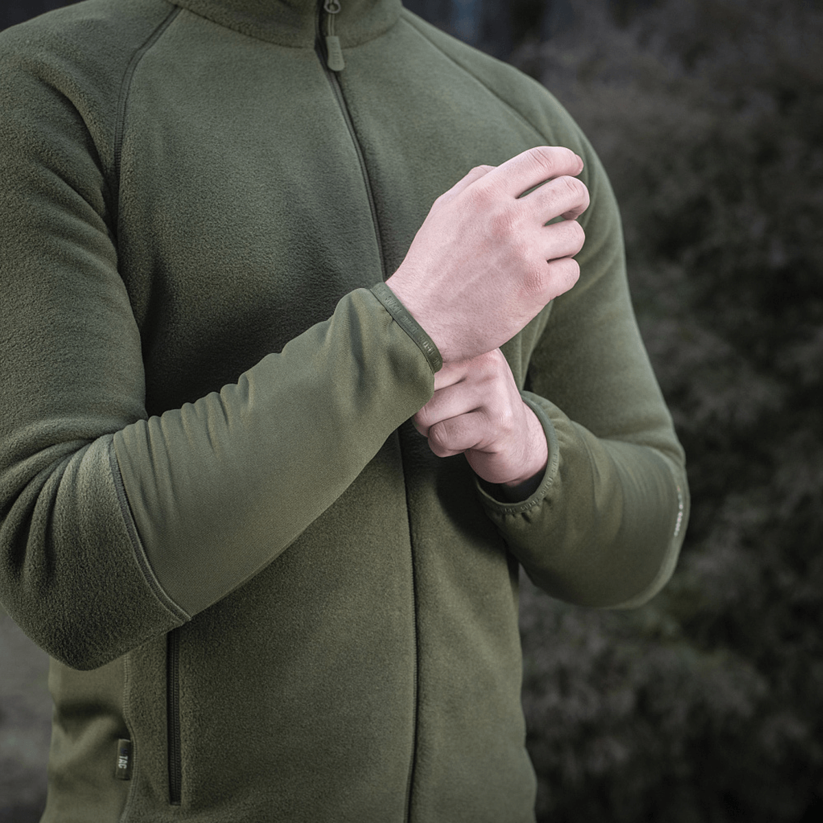 Person iført M-Tac Polartec Sport Fleecejakke i olivengrøn, fokuseret på komfort og stil til både yderlag og mellemlag.