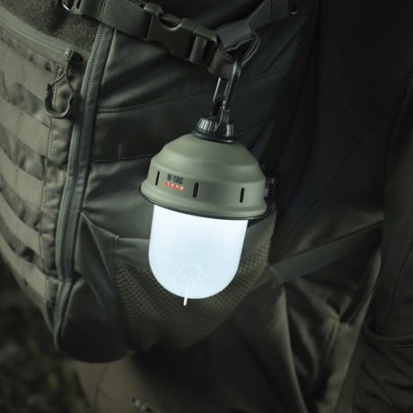 M-Tac Turist Hengelampe hengende på ryggsekk, ideell for camping og jakt. LED-lys med tre funksjoner, lading via USB, robust og funksjonell.
