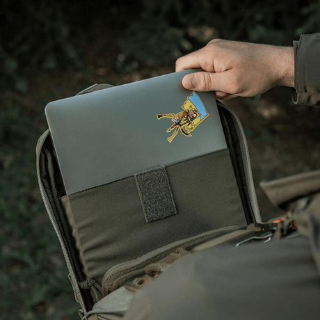 Person opening M-Tac Tablet Bag Laser Cut Hex with a laptop inside, showcasing quick access compartment.
