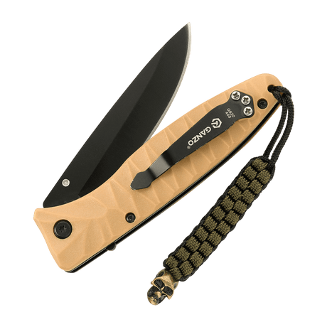 M-Tac Knife Lanyard Cuboid Skull med flettet paracord og dekorativ Cuboid Skull-perle, vedhæftet på foldbar kniv med åbent blad.