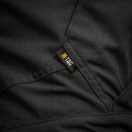 Detalje af M-Tac Bukser STURM NyCo Extreme Gen.II med robust syning og mærke. Materiale NYCO Extreme for holdbarhed og komfort.