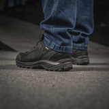 Person wearing M-Tac Jeans Aggressor showcasing durable denim and tactical functionality, perfect for outdoor activities.