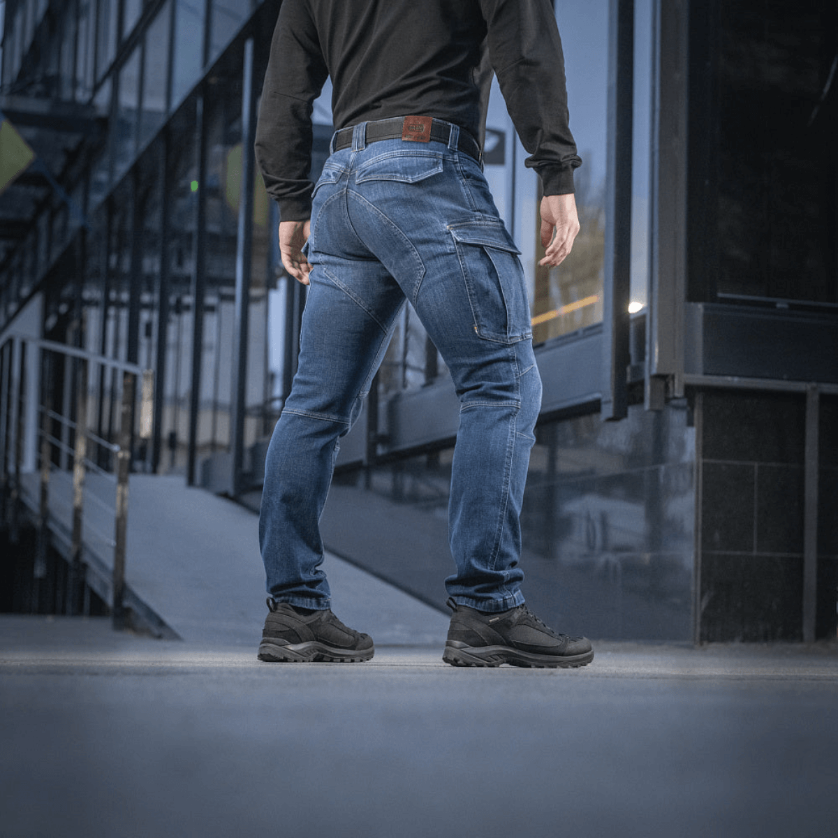 M-Tac Jeans Aggressor i slidstærkt denim med funktionelle lommer set bagfra, perfekte til bevægelsesfrihed og komfort.