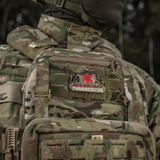 Camouflage uniform with paramedic patch displaying "Odin will wait Paramedicine" emblem